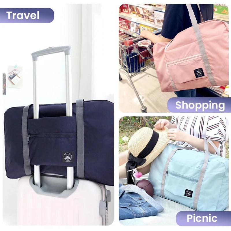 A foldable travel duffel bag in navy blue and light pink is shown with a rolling suitcase and a light blue bag being used for