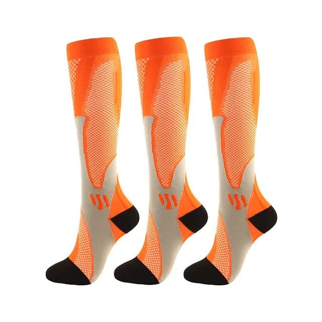 A set of three orange compression socks for athletes and medical use shown from the side.