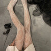 Pair of sheer beige floral rattan fishnet hosiery worn on legs against a gray background.