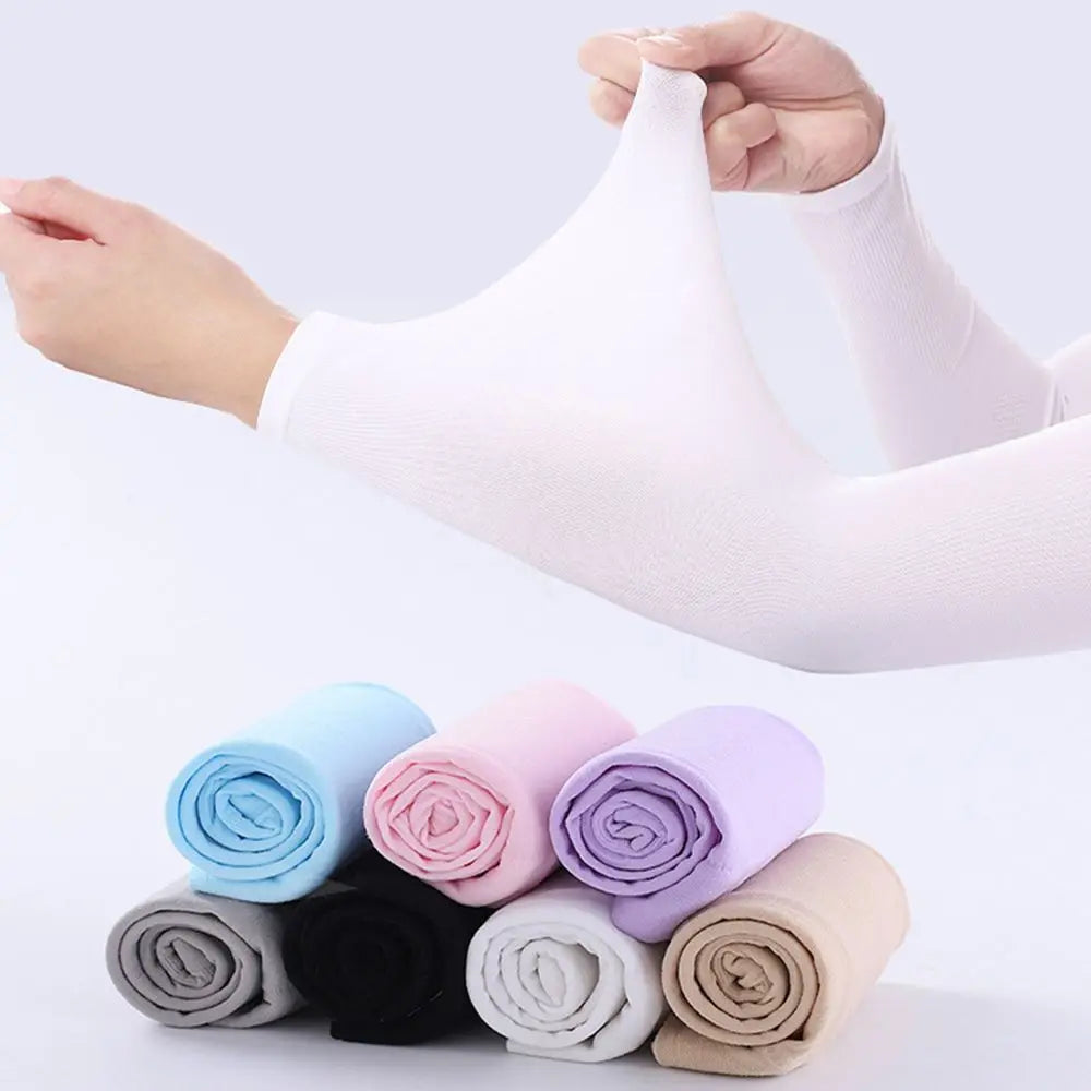 A hand is stretching a white arm sleeve, with several rolled arm sleeves in various pastel colors arranged below.