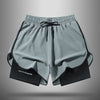 Gray athletic shorts with black trim and drawstring, shown flat lay.