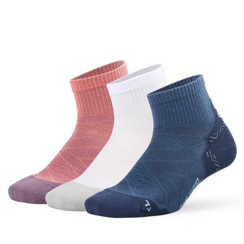 A stack of breathable performance running socks in shades of pink, white, and navy blue.