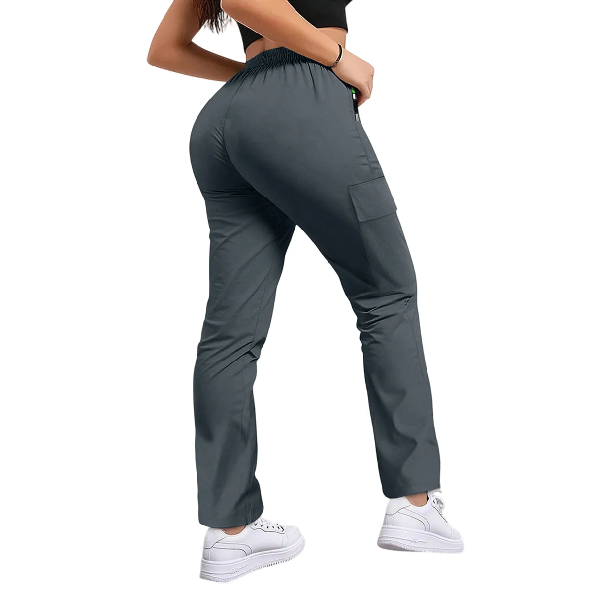 A woman wearing dark gray women's straight fit drawstring cargo pants and white sneakers.