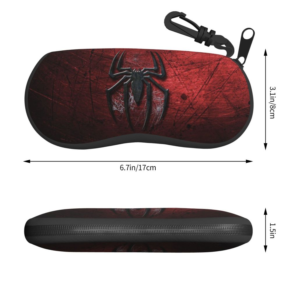 A dark red leather pouch with a black spider web design and a metal clasp.