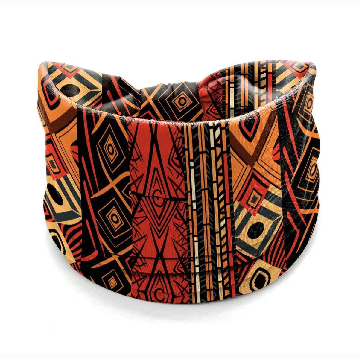 A close-up of a patterned bohemian stretch cotton headband featuring geometric designs in orange, black, and rust tones.