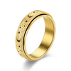 A gold-toned stainless steel ring featuring a textured band decorated with small stars and crescent moons.