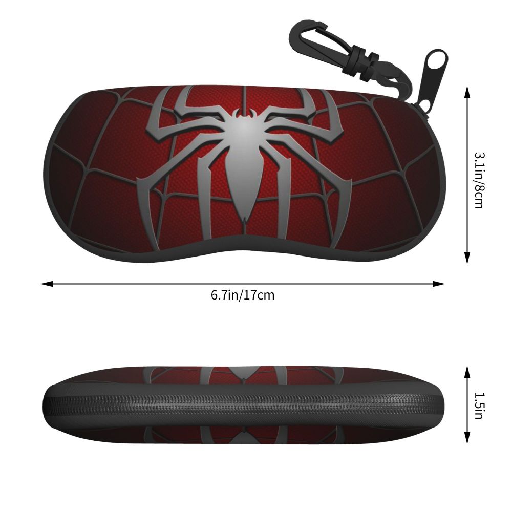 A dark red eyeglass pouch featuring a silver spider web design and a black strap.