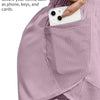 A close-up of a light purple athletic short featuring a mesh pocket used to secure a smartphone.