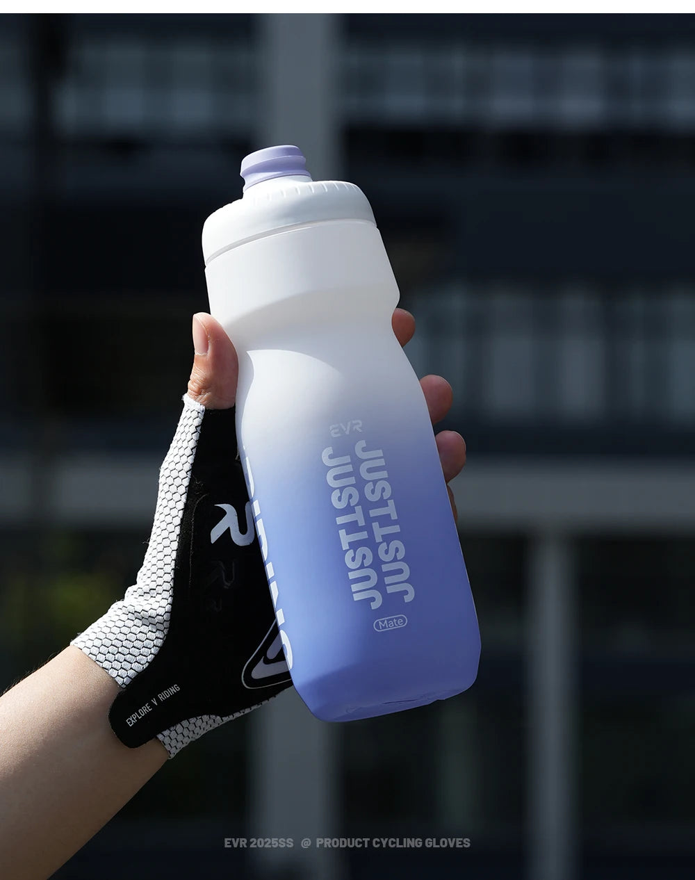 A hand holds a white squeezable cycling water bottle against a dark background.