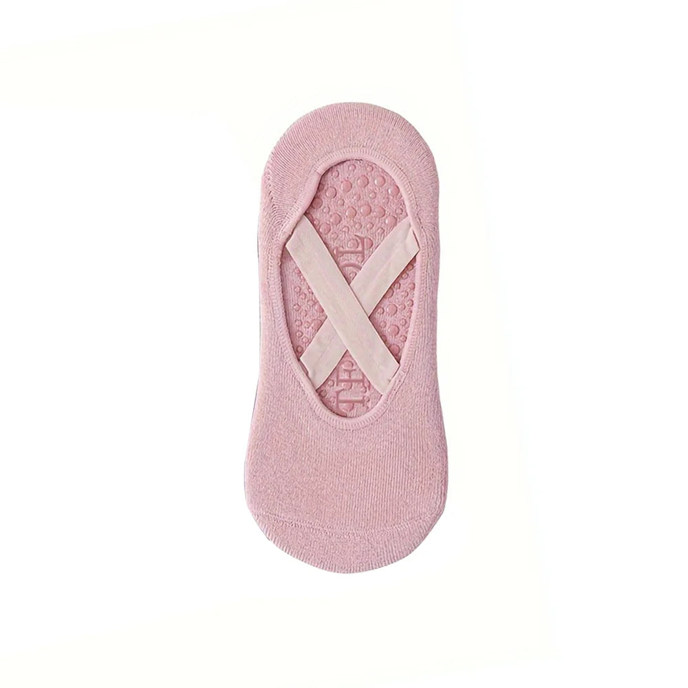 Un par de calcetines deportivos de silicona rosa antideslizantes para yoga y pilates