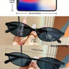 A set of black retro fashion sunglasses with rectangular and oval frames shown next to a smartphone for size comparison.