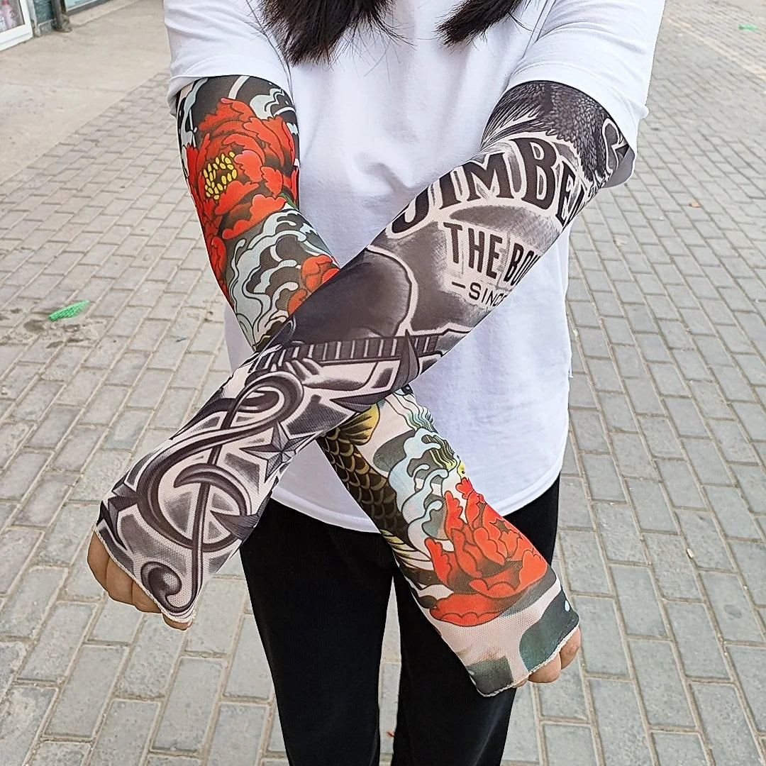 A person wearing long-sleeved tattoo arm sleeves featuring floral and geometric designs.