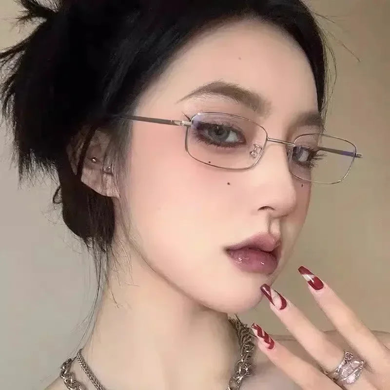 A close-up portrait of a woman wearing retro square frame eyeglasses with subtle silver detailing.