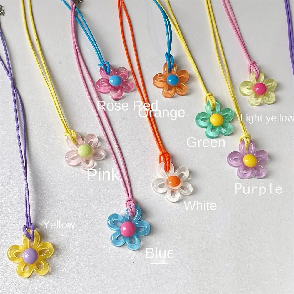 A collection of colorful punk style motorcycle guardian bell pendants featuring various flower shapes and colors.