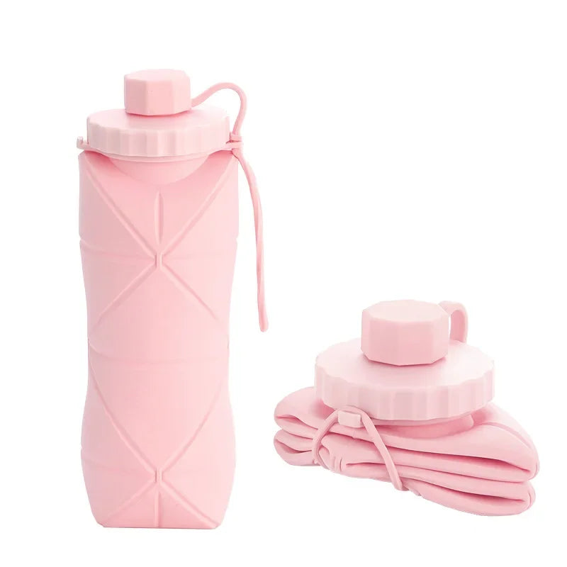 A pink silicone folding water bottle with a screw top and a folded pink cloth accessory.