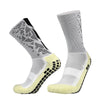 A pair of white and black anti-slip silicone football socks shown from the side.