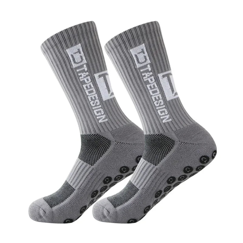 A pair of gray anti-slip performance sports socks shown from the side.