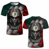 A dark green and red graphic t-shirt featuring a stylized Aztec or indigenous face design with a feathered headdress and the 