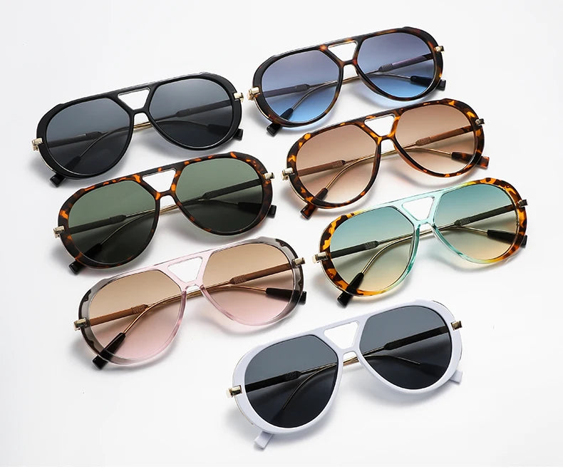 A collection of vintage oversized designer sunglasses in various shades of brown, black, and amber.