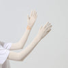 A pair of beige UPF 50+ sun protection arm sleeves worn on a person's arms.