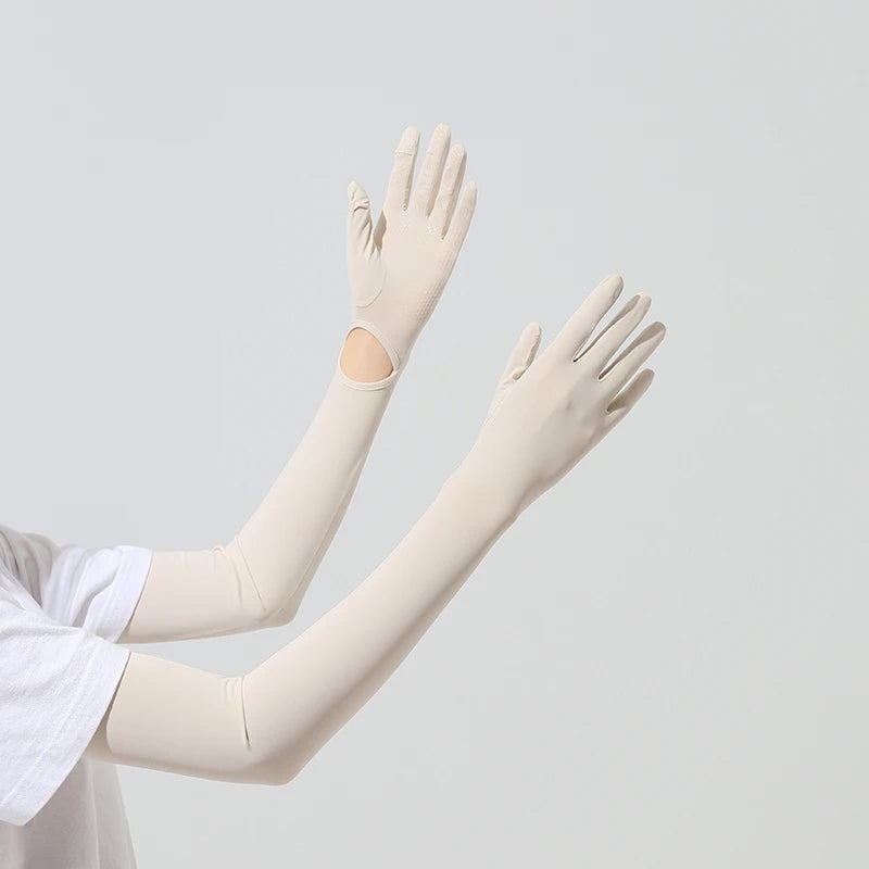 A pair of beige UPF 50+ sun protection arm sleeves worn on a person's arms.