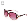 A pair of red vintage oversized retro sunglasses with a gold-toned detail.