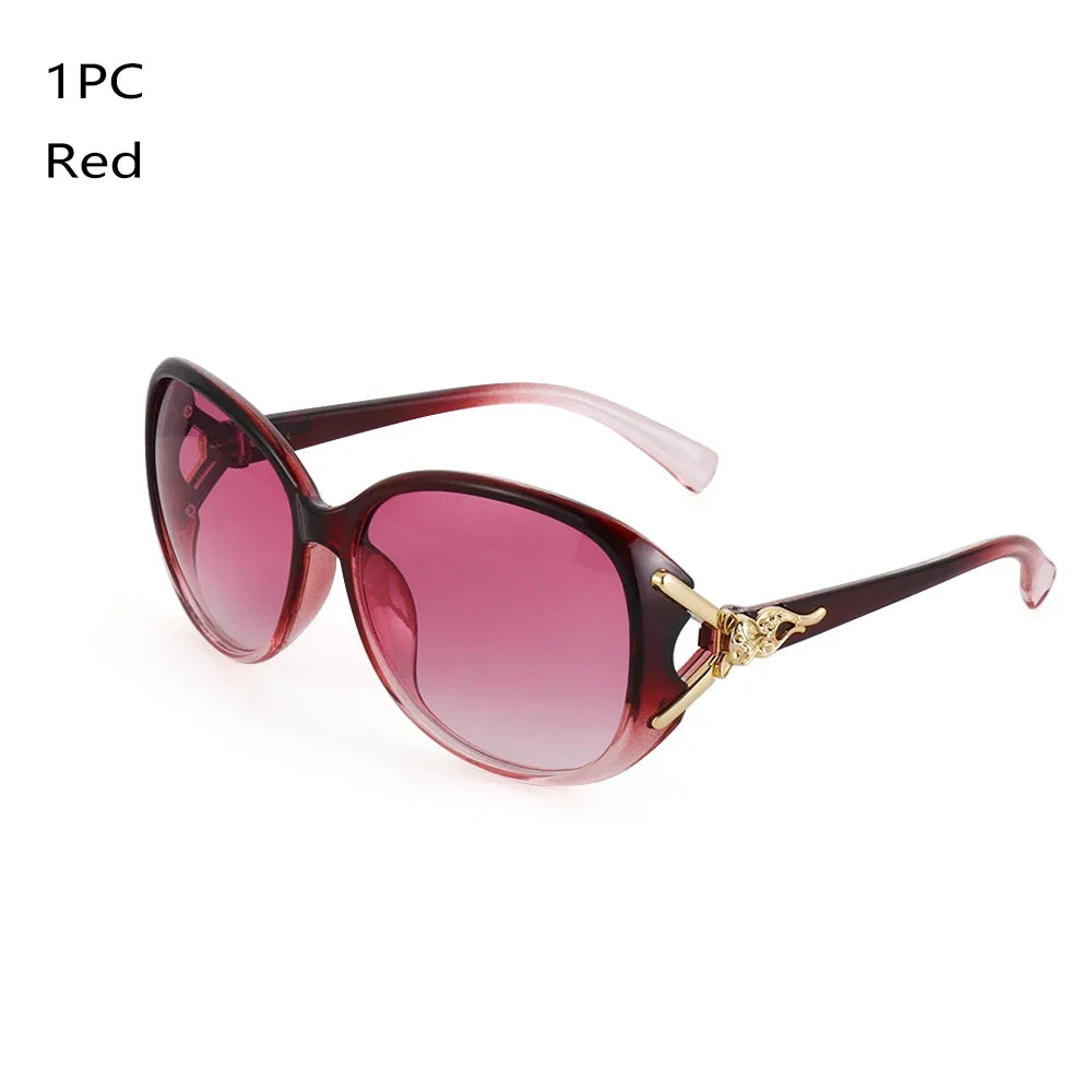 A pair of red vintage oversized retro sunglasses with a gold-toned detail.