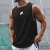 A man wearing a black sleeveless sports tank top with a white stripe logo, standing outdoors.
