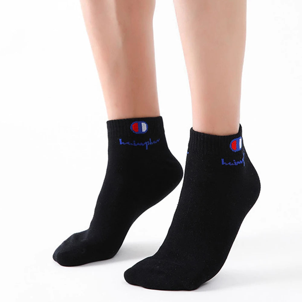 A pair of men's classic black and white ankle socks with a striped logo on the cuff.