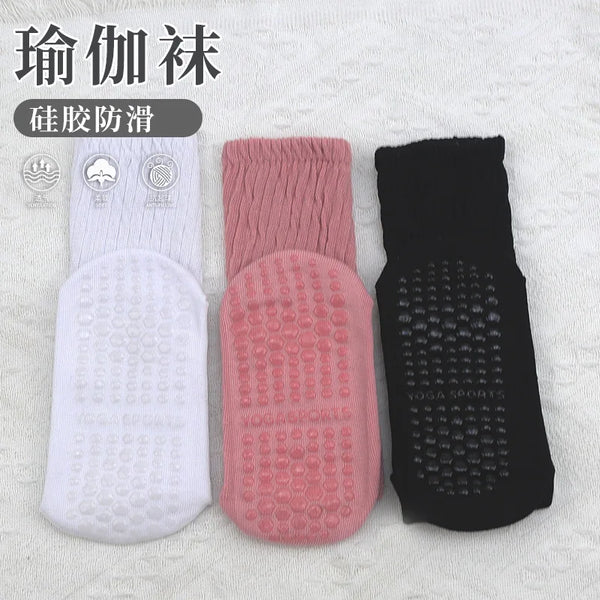 A set of three silicone socks for foot protection and exercise, shown in white, pink, and black.