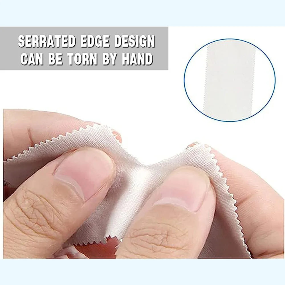 A hand is tearing a piece of light pink athletic finger tape, demonstrating its serrated edge design.