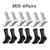 Six pairs of black athletic grip socks with white geometric patterns.