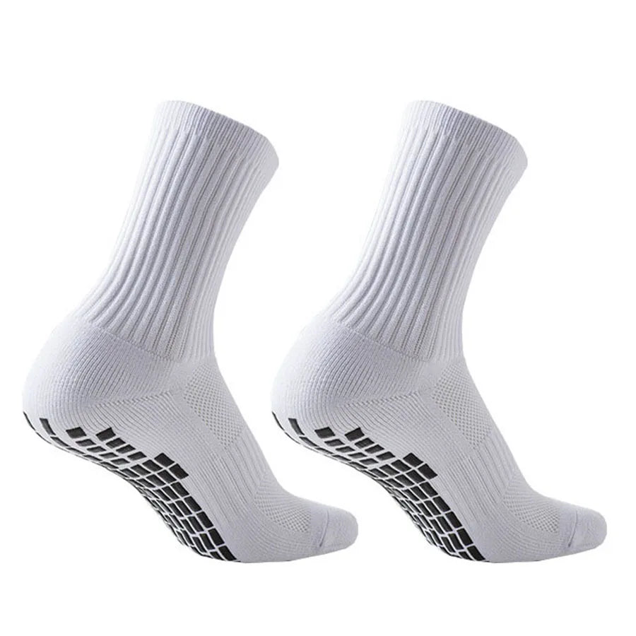 A pair of white athletic grip socks shown from the side.