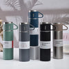A collection of five 500ml stainless steel vacuum flasks in various shades of green, gray, and black.
