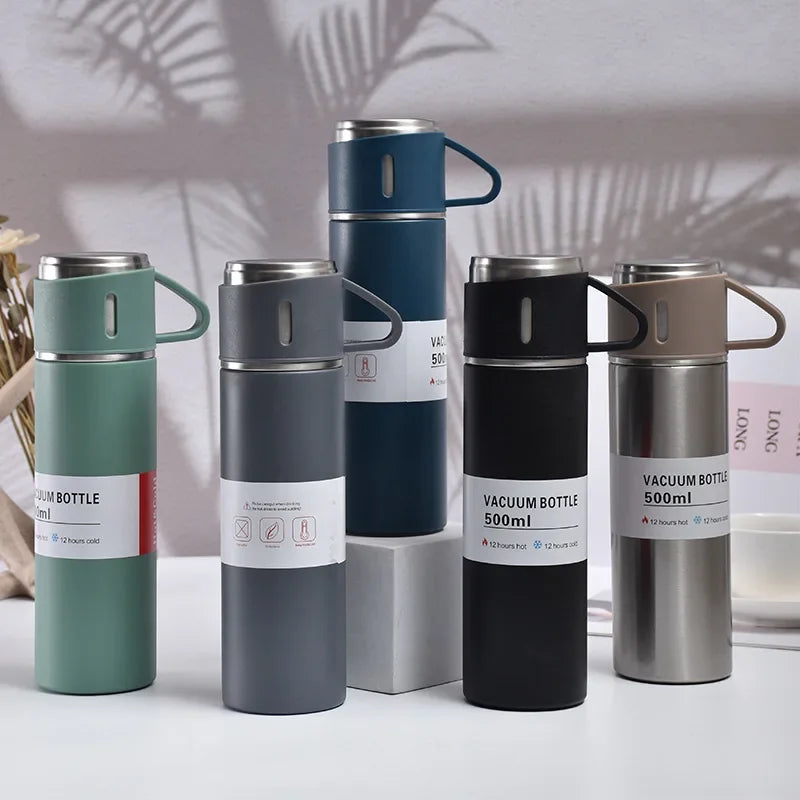 A collection of five 500ml stainless steel vacuum flasks in various shades of green, gray, and black.