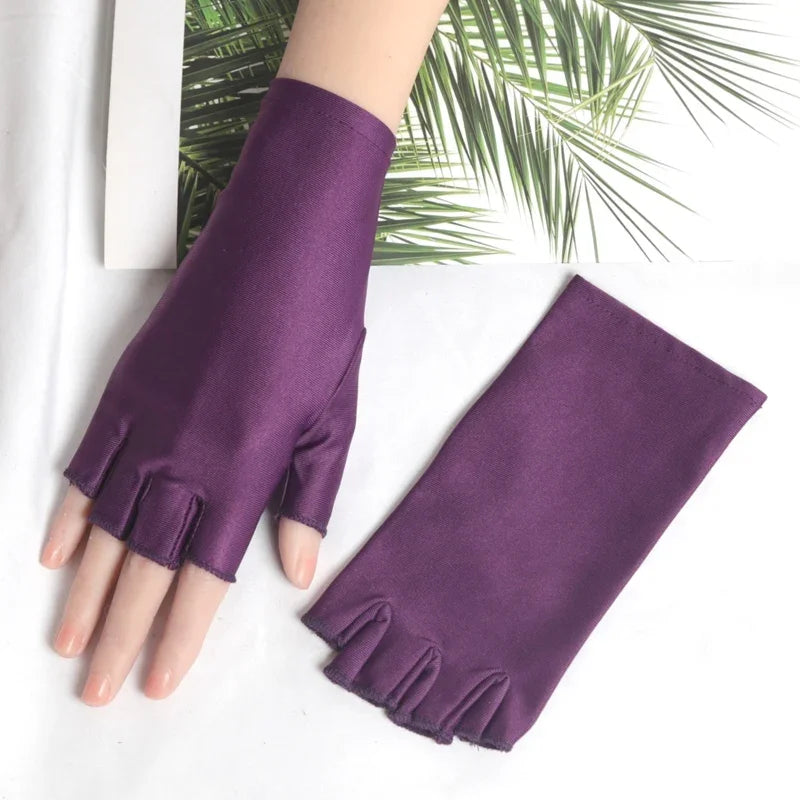 Purple women's thin stretch elastane gloves shown on a hand against a tropical leaf background.