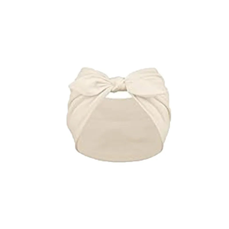 A beige solid bow headband for hair styling and workout.