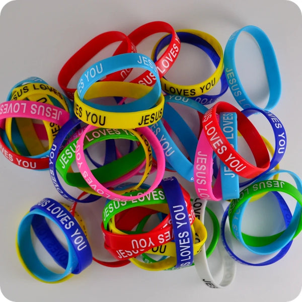A collection of silicone religious bangle bracelets in various colors including red, blue, yellow, and pink.