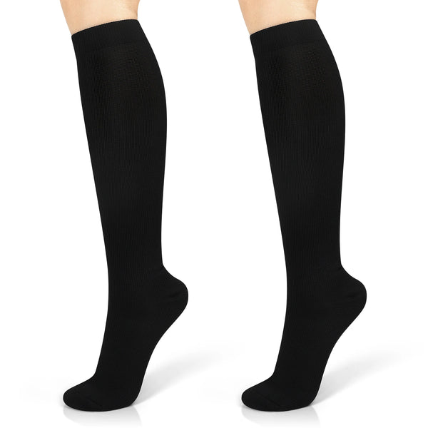 A pair of black moisture-wicking sports compression socks shown on a foot.