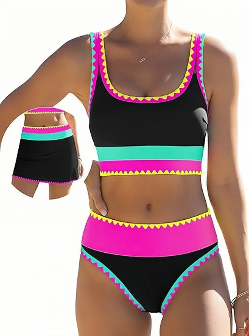 A model wears a color-block zigzag three-piece swimsuit set featuring black, pink, and teal stripes.