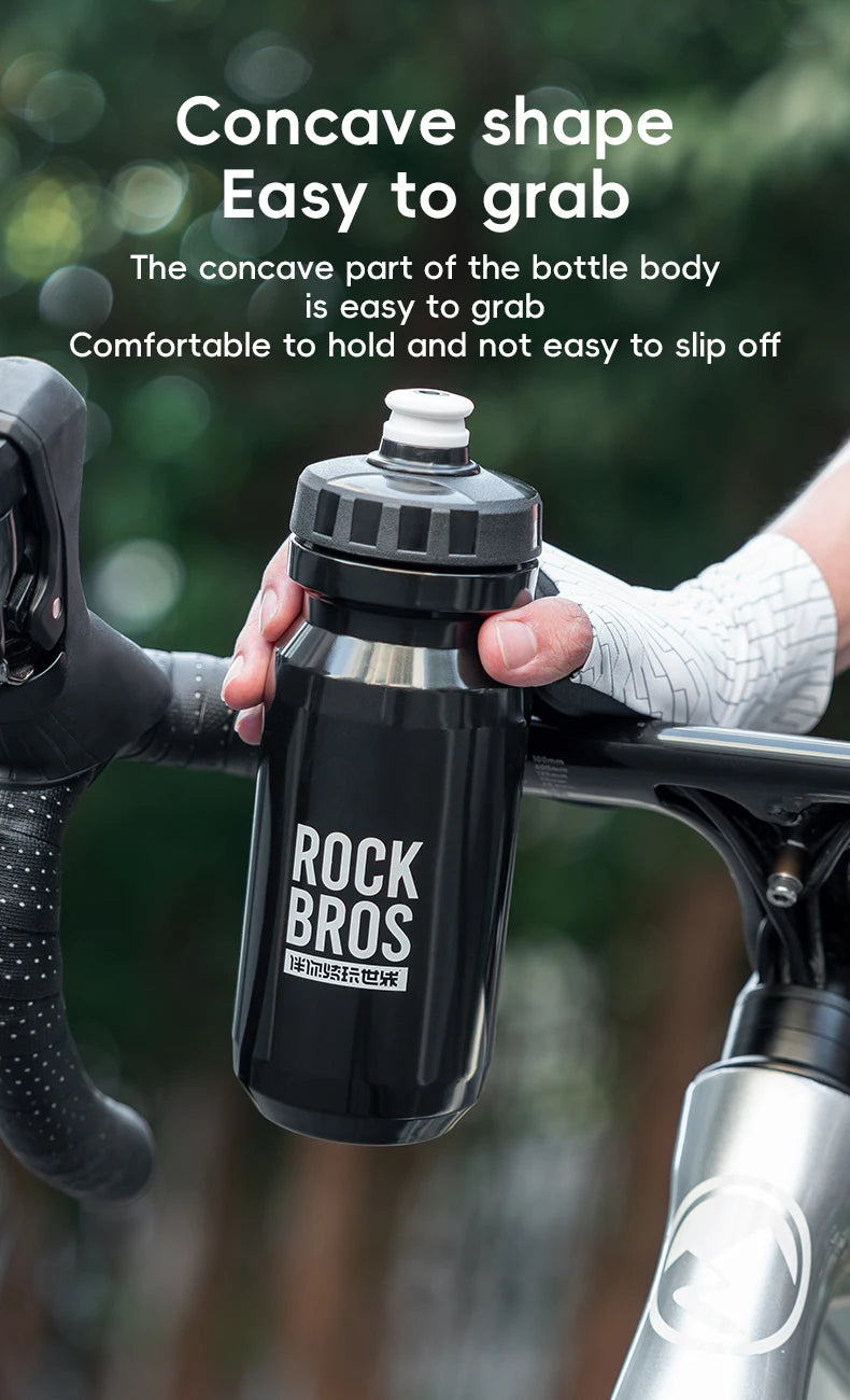 A black Rock Bros sports water bottle is shown being held by a hand, demonstrating its concave shape for easy gripping.