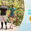 A man and a woman walking outdoors on a wooden deck, demonstrating open-toe socks.