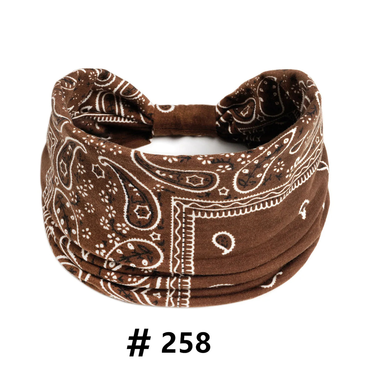 A brown boho print cotton headband with white embroidery, shown flat.