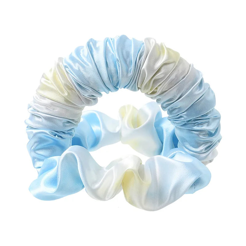 A light blue and white satin heatless curling rod headband coiled into a circular shape.