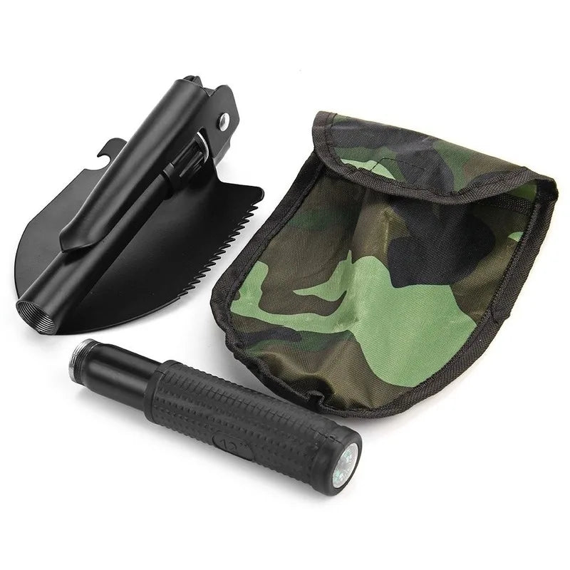 A black foldable multi-tool shovel is shown with its protective cover and blade attached.