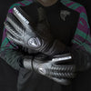 Black leather goalkeeper gloves with the Atlander logo worn by a person.