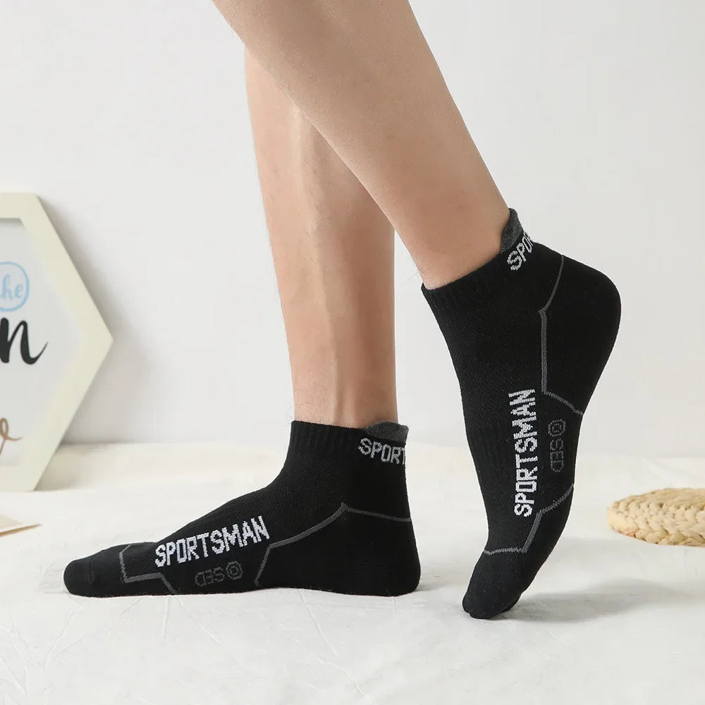 A pair of black men's sports socks with the text SPORTSMAN visible on the calf.