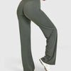 A person is modeling high-waist olive green yoga pants with a white top.