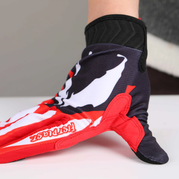A close-up of red and white cycling riding gloves worn on a foot, with black padding visible.