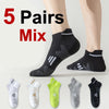 Five pairs of mixed colored breathable running socks displayed on a person's foot.